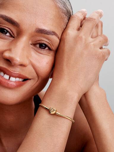 Slangenschakelarmband met stamboommotief en hartvormige sluiting